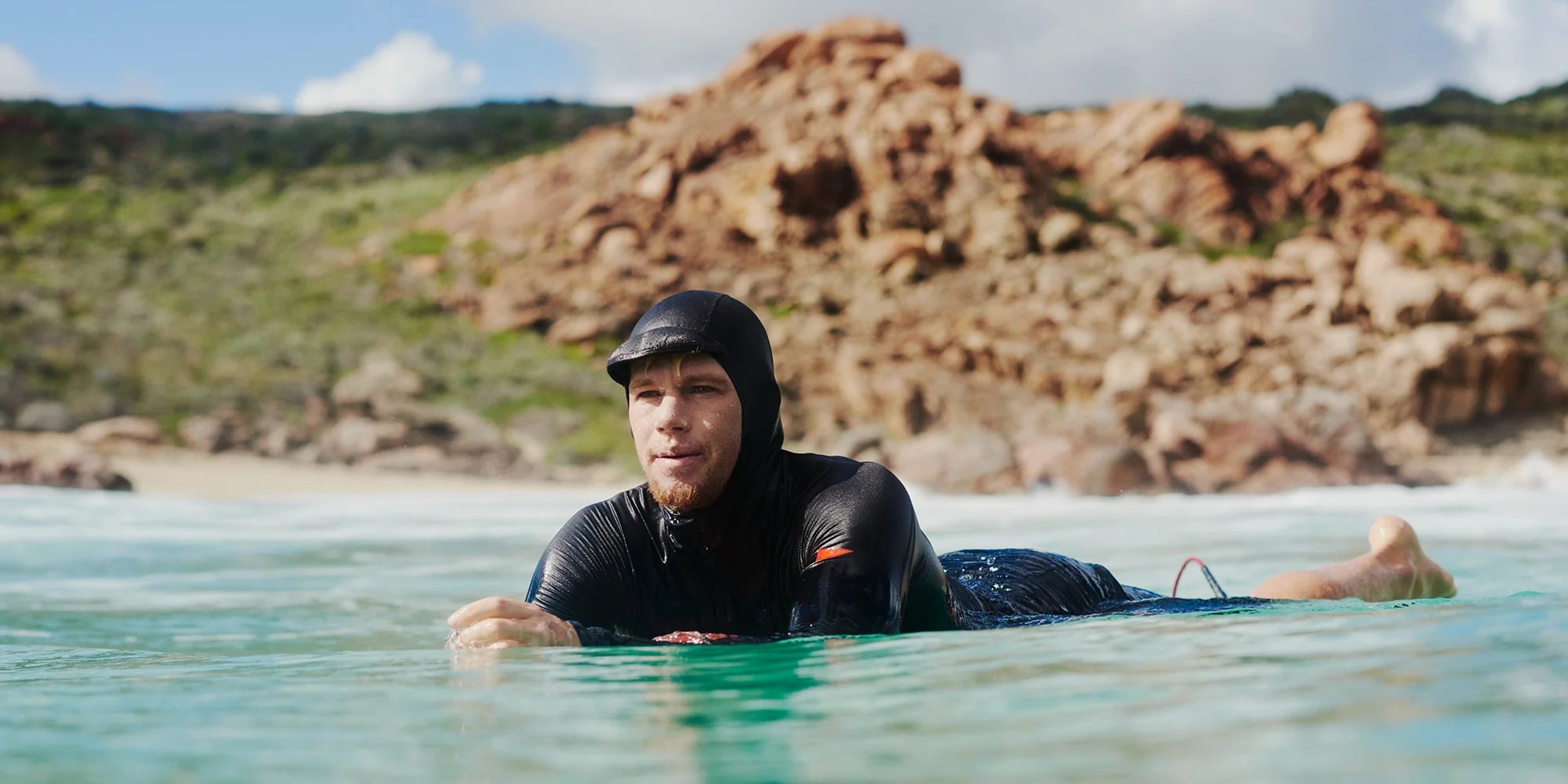 john john florence in water with a hooded long sleeve upf shirt